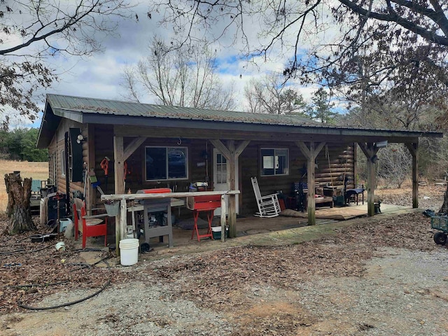 rear view of property with a porch