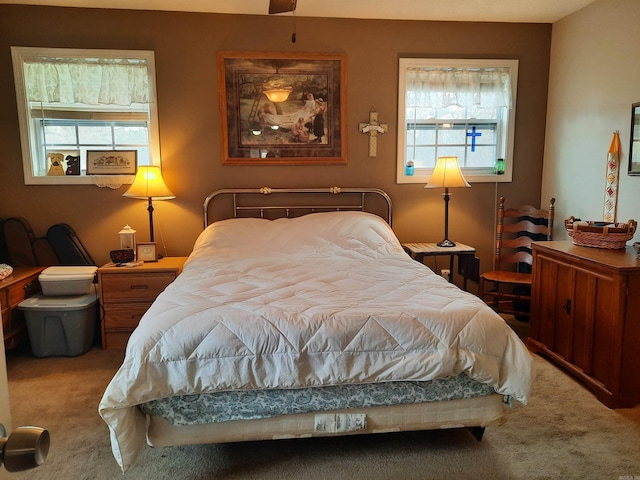 carpeted bedroom featuring multiple windows