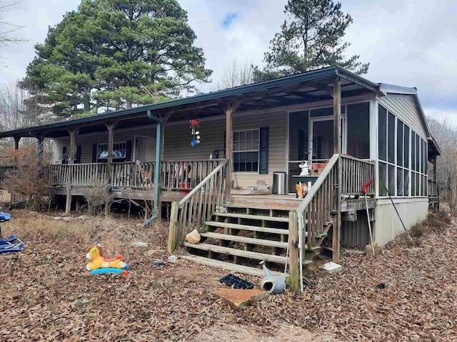 view of front facade featuring a sunroom and covered porch