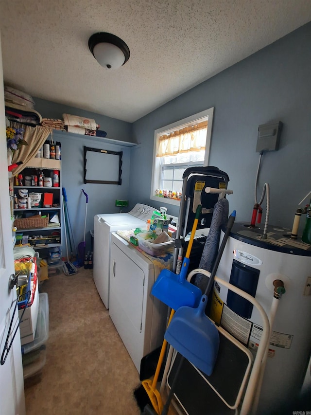 laundry area featuring washer and dryer, electric water heater, and a textured ceiling