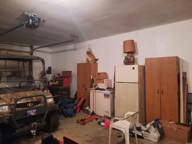 garage with white refrigerator and a garage door opener