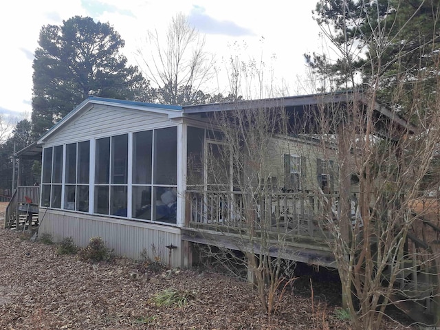 view of side of home with a sunroom