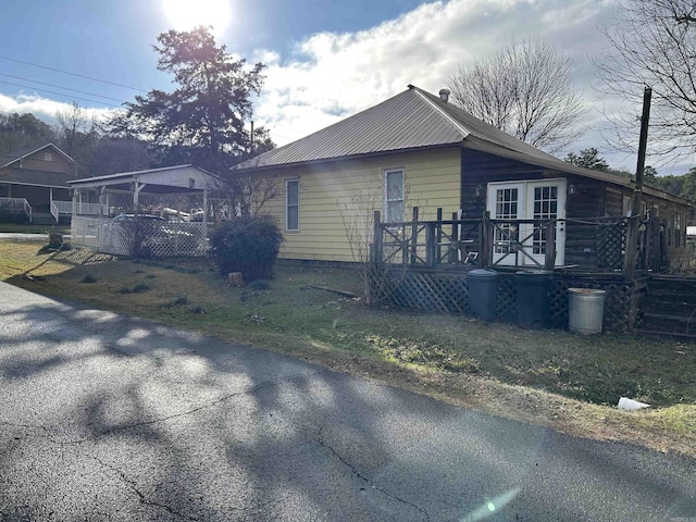 view of side of property featuring a wooden deck