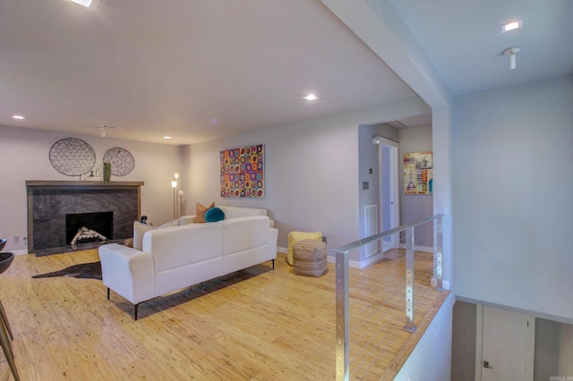 living room featuring hardwood / wood-style flooring and a fireplace