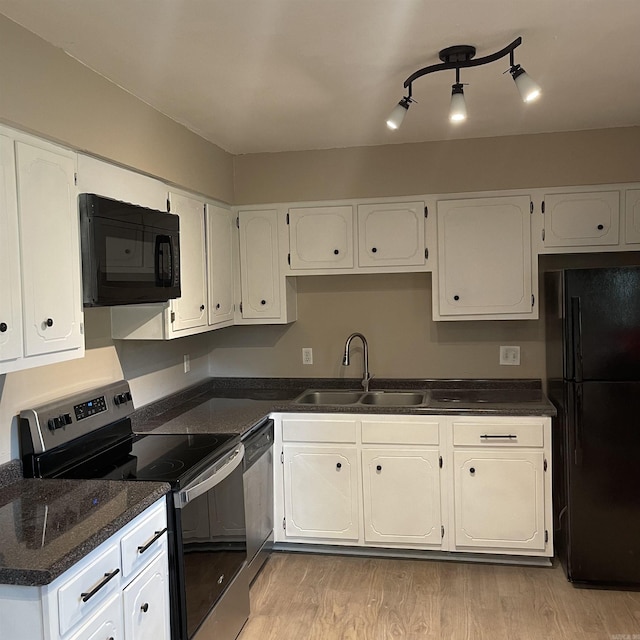 kitchen featuring white cabinetry, sink, black appliances, and light wood-type flooring