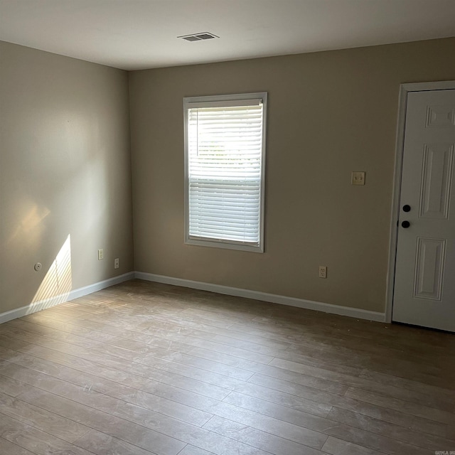 spare room with light hardwood / wood-style floors