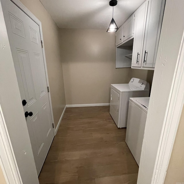 washroom featuring cabinets, separate washer and dryer, and light hardwood / wood-style flooring