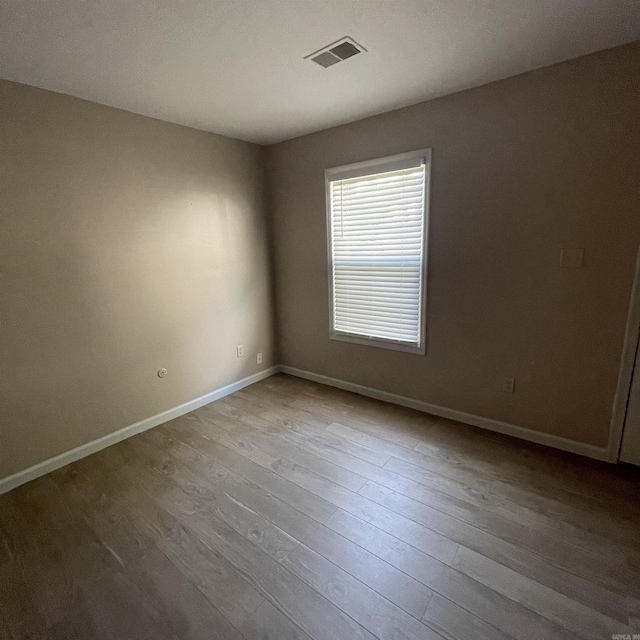 unfurnished room with light wood-type flooring