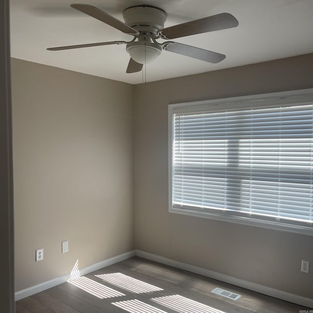 empty room featuring ceiling fan and hardwood / wood-style floors