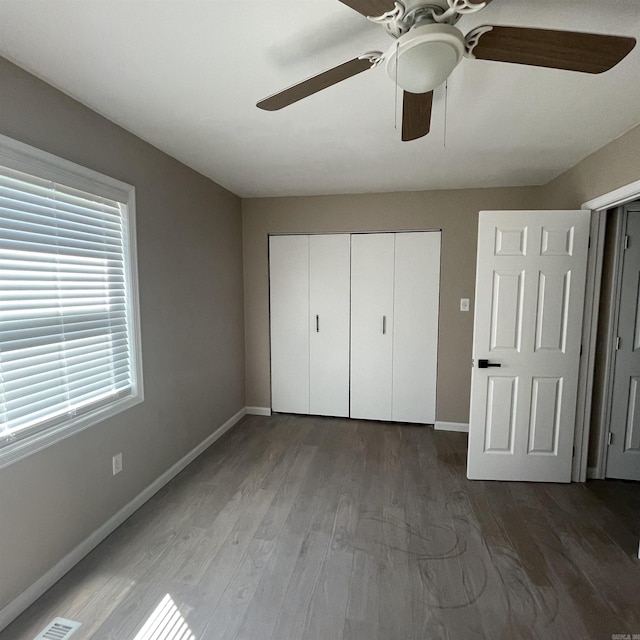 unfurnished bedroom with a closet, ceiling fan, and hardwood / wood-style flooring