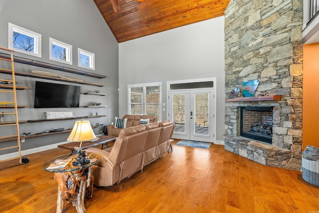 living room with french doors, high vaulted ceiling, hardwood / wood-style floors, a fireplace, and wood ceiling