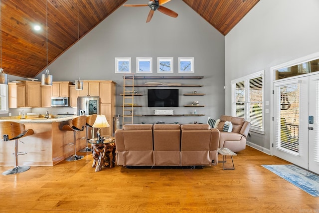 living room with ceiling fan, high vaulted ceiling, wooden ceiling, and light wood-type flooring