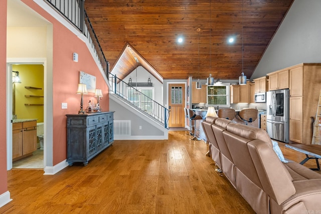 living room featuring light wood-type flooring, high vaulted ceiling, and wooden ceiling