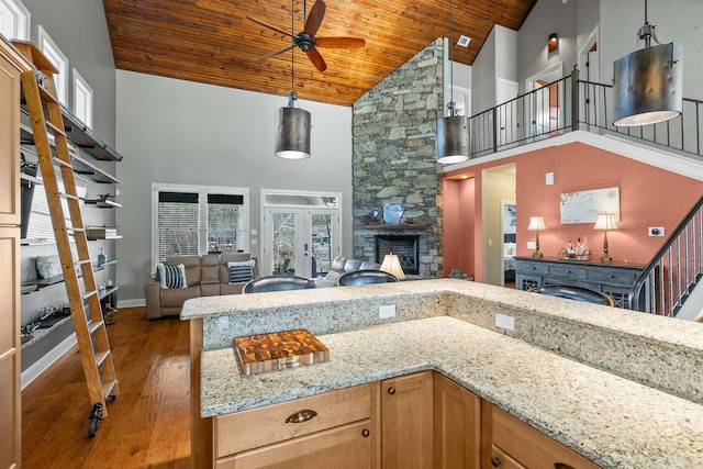 kitchen with hanging light fixtures, high vaulted ceiling, wooden ceiling, and french doors