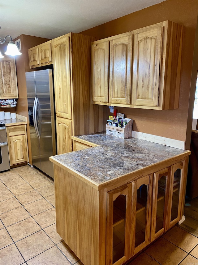 kitchen with kitchen peninsula, stainless steel refrigerator with ice dispenser, a chandelier, and light tile patterned flooring