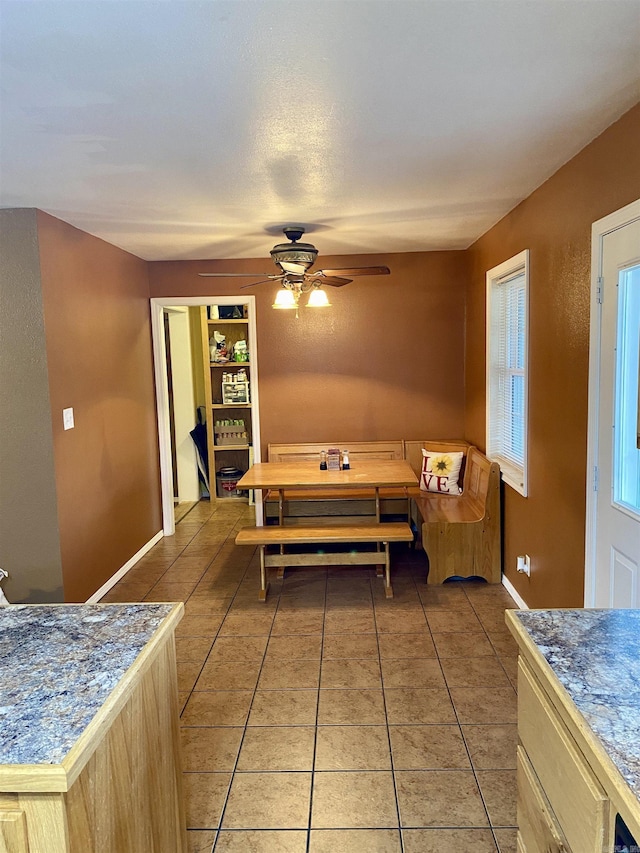 tiled dining room featuring ceiling fan