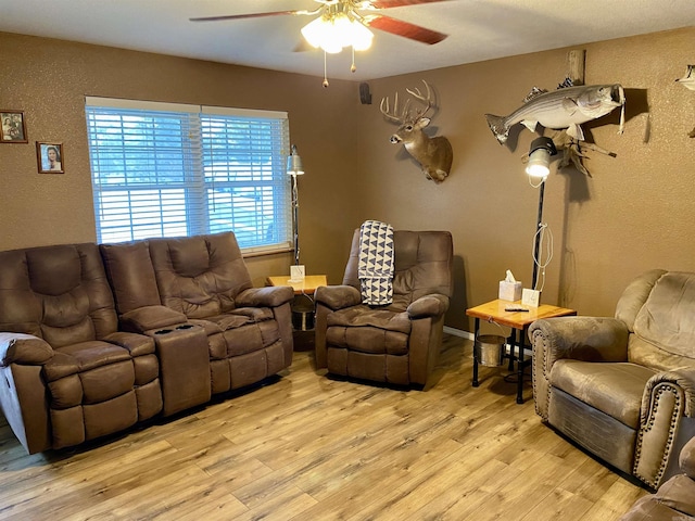 living room with ceiling fan and light wood-type flooring