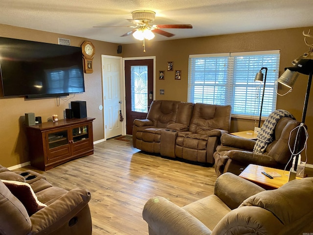 living room with light hardwood / wood-style flooring and ceiling fan