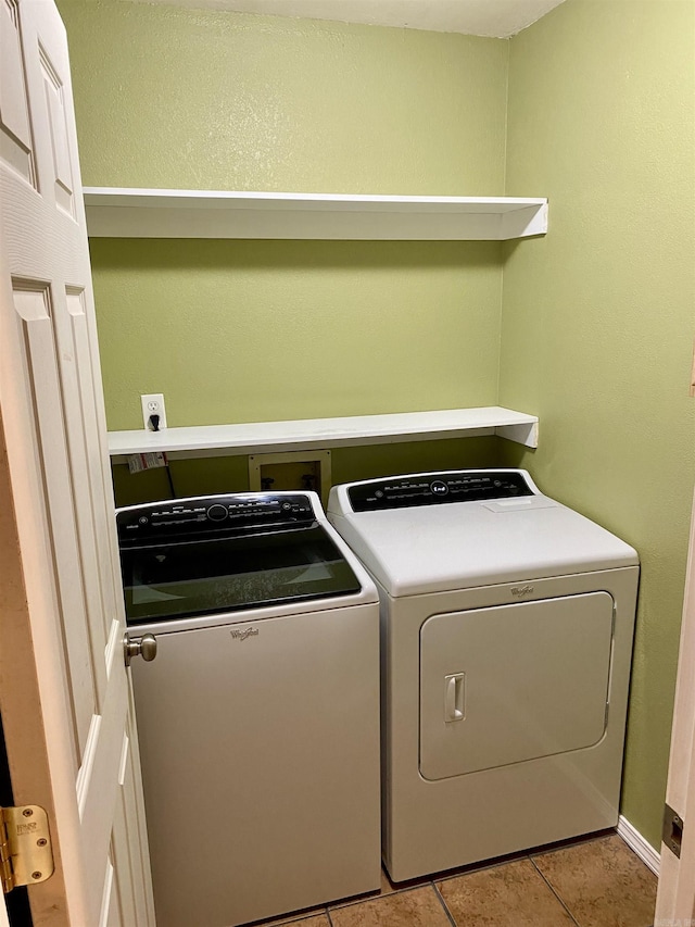 laundry room with light tile patterned floors and washing machine and dryer