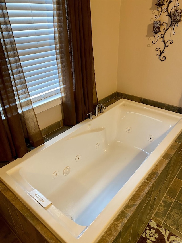 bathroom featuring tile patterned floors and tiled bath