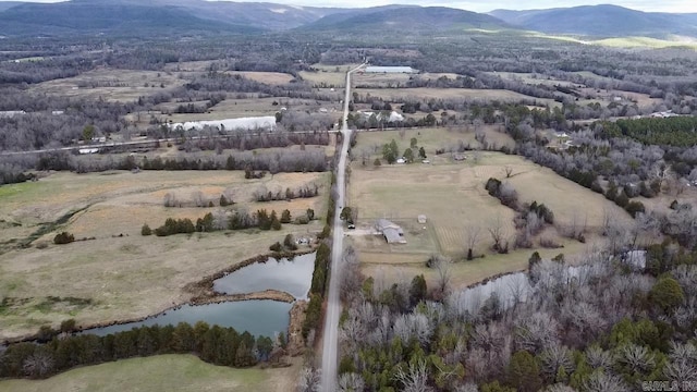 birds eye view of property featuring a water and mountain view and a rural view