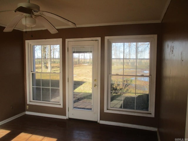 doorway to outside with ceiling fan and crown molding