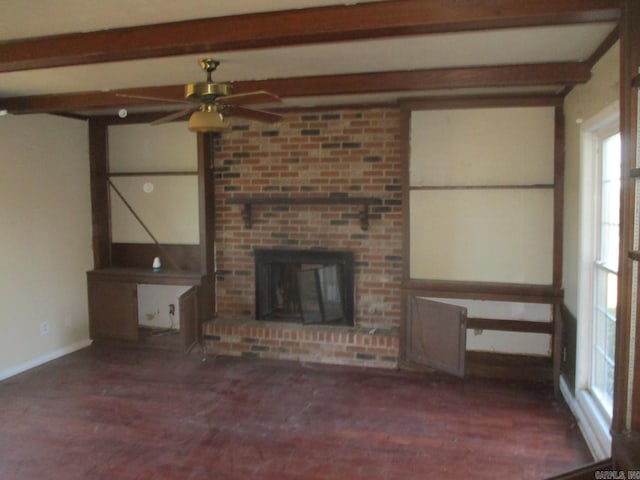 unfurnished living room with ceiling fan, beam ceiling, and a fireplace