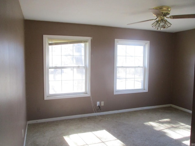 empty room featuring ceiling fan and light carpet