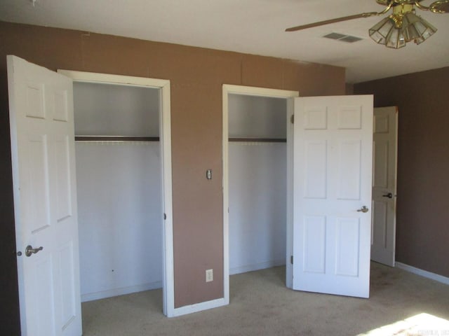 unfurnished bedroom featuring ceiling fan and light colored carpet