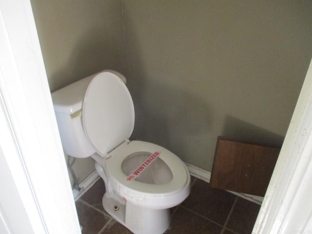 bathroom with toilet and tile patterned floors