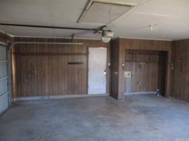 garage featuring wooden walls and a garage door opener