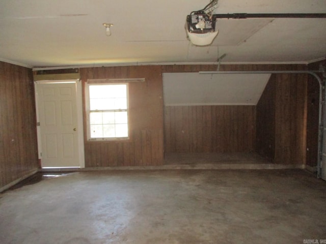 garage with a garage door opener and wooden walls