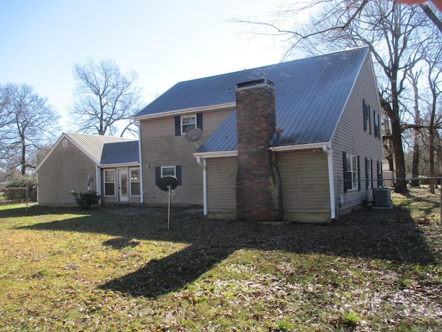 back of property featuring a yard and central AC unit