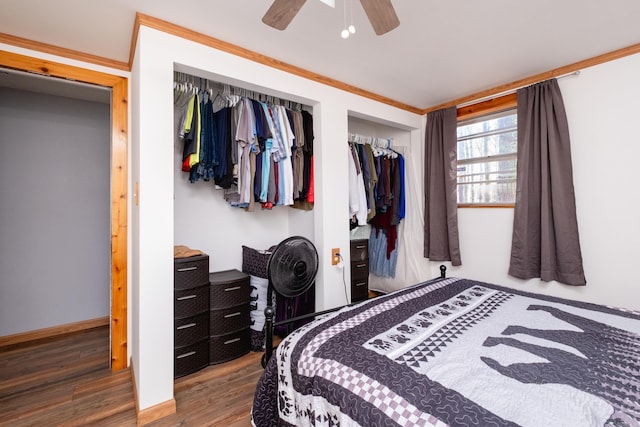 bedroom with a closet, ceiling fan, hardwood / wood-style floors, and crown molding