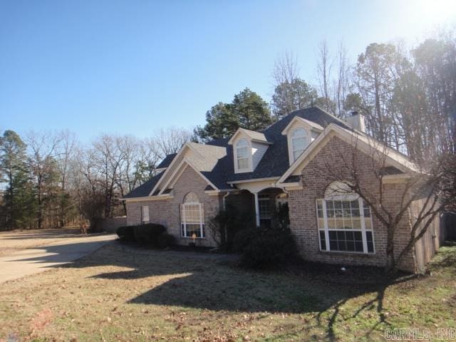 view of property featuring a front lawn