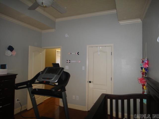 bedroom featuring ceiling fan and ornamental molding