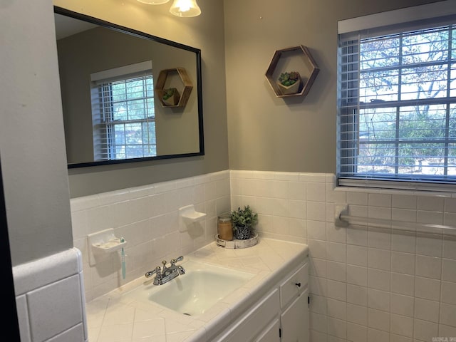 bathroom with vanity and tile walls