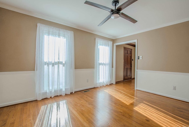 unfurnished room with light hardwood / wood-style flooring, ceiling fan, and crown molding