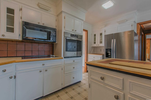 kitchen with decorative backsplash, stainless steel appliances, white cabinetry, and crown molding