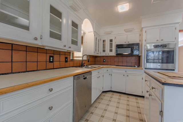 kitchen featuring sink, ornamental molding, appliances with stainless steel finishes, tasteful backsplash, and white cabinetry