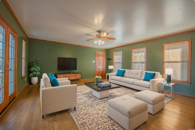 living room with ceiling fan, french doors, light hardwood / wood-style floors, and ornamental molding