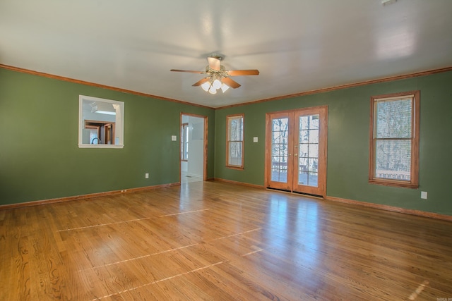 unfurnished room featuring ceiling fan, light hardwood / wood-style floors, crown molding, and french doors