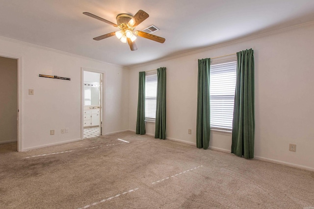 carpeted empty room with ceiling fan and ornamental molding