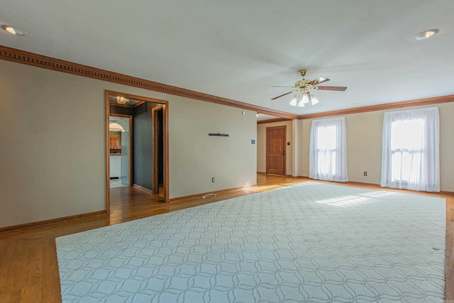 unfurnished room with hardwood / wood-style floors, ceiling fan, and crown molding