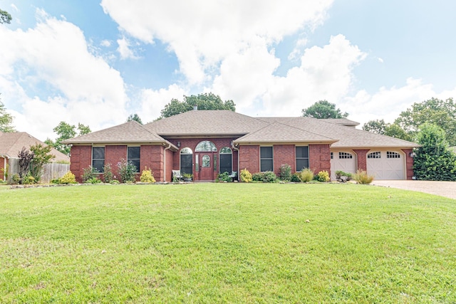 ranch-style home featuring a garage and a front lawn