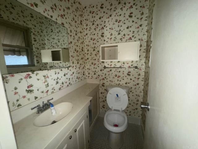 bathroom featuring tile patterned floors, vanity, and toilet