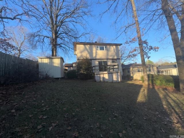 back of property featuring a shed