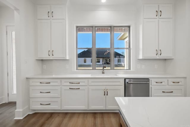 kitchen with a wealth of natural light, sink, and white cabinets