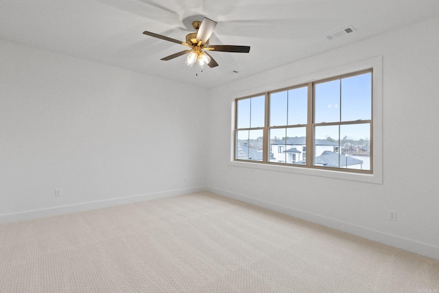 unfurnished room featuring ceiling fan and light carpet