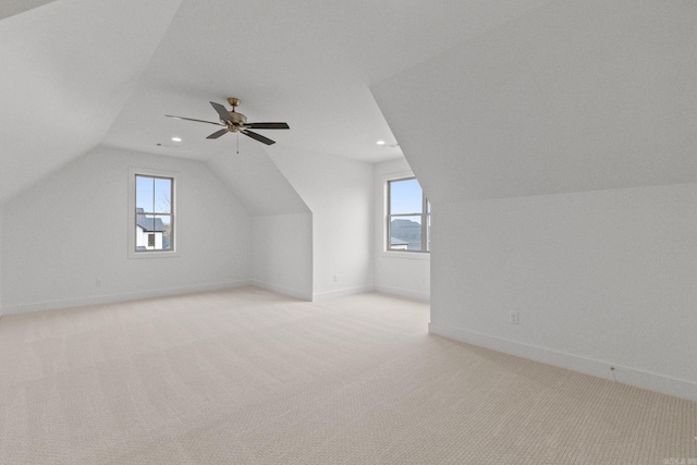 bonus room with ceiling fan, light carpet, and vaulted ceiling